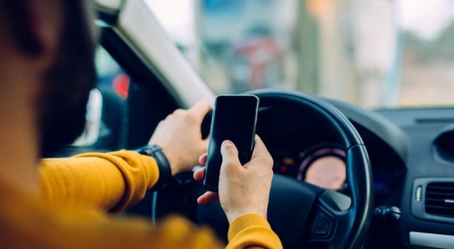 Man-on-phone-in-car-640x351-Aug-19-2025-01-40-46-7867-PM